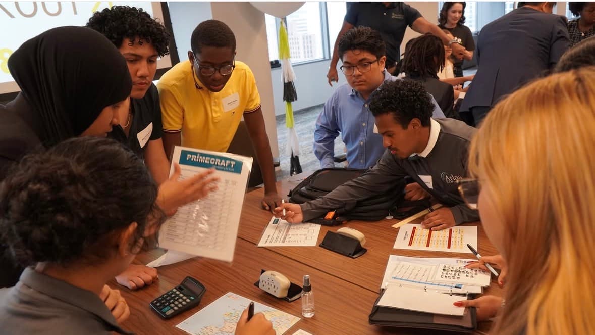 Scholars collaborating on a project during a session